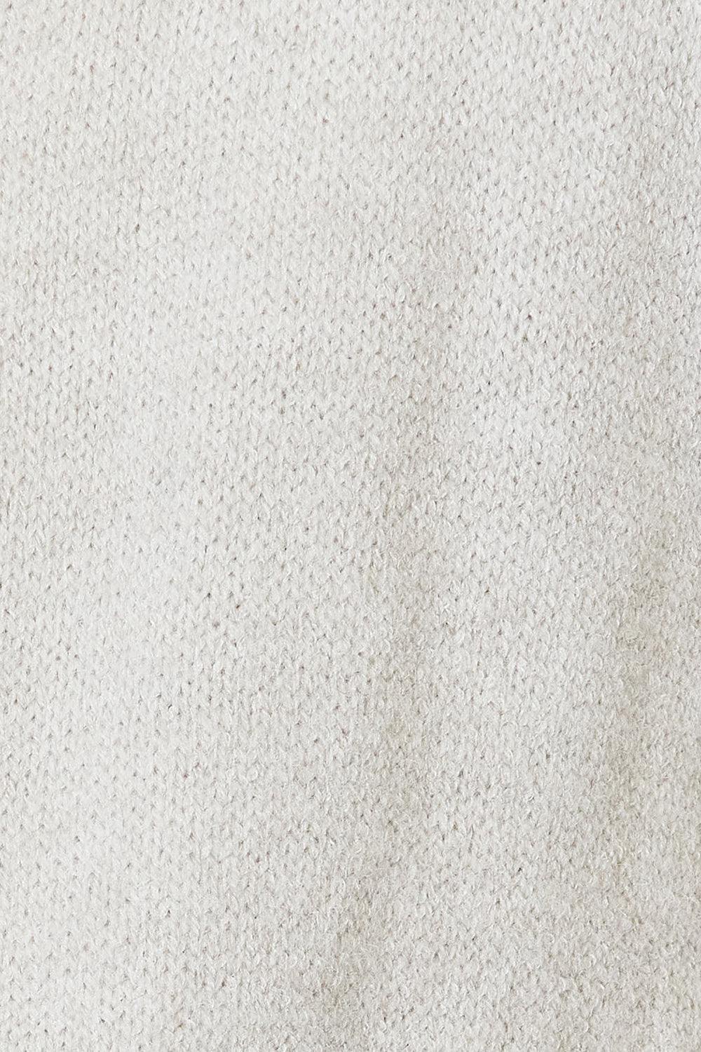 A close-up of a white, knitted fabric with a textured pattern reveals small, uniform stitches that create a soft, woolly appearance. This cozy design enhances the allure of an Angel Wings Open Front Duster Cardigan with Pockets, featuring its flowy silhouette.