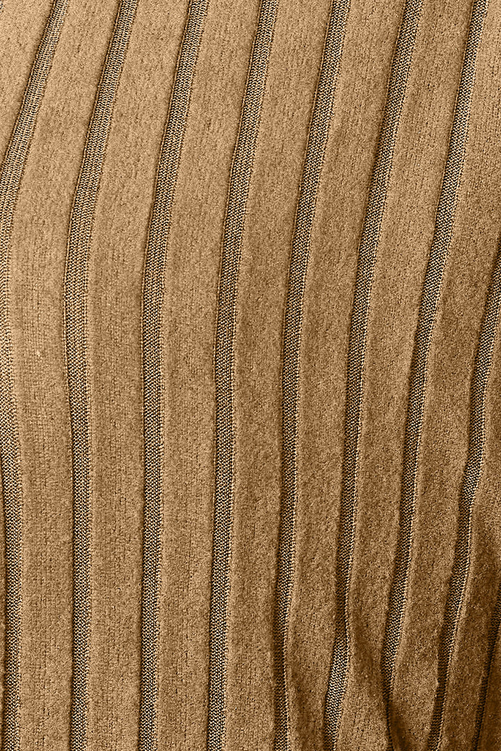 Close-up of the slightly stretchy fabric from the Basic Bae Full Size Ribbed Cocoon Cardigan, showcasing vertical stripes in a golden-brown hue. The texture appears soft, with ribbed lines creating a pattern of alternating light and shadow, characteristic of basic style essentials.