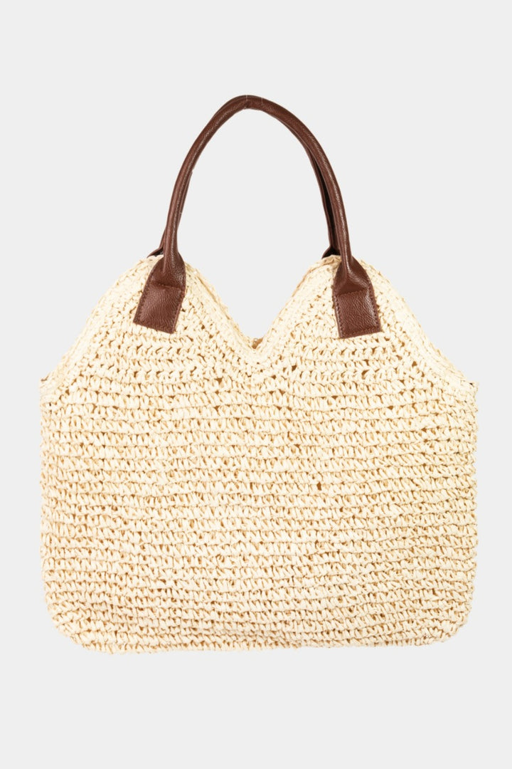 The Fame Straw Braided Faux Leather Strap Shoulder Bag features a woven beige straw design with two brown faux leather straps, set against a plain white background. Its detailed texture and organic design create a casual yet stylish appearance.