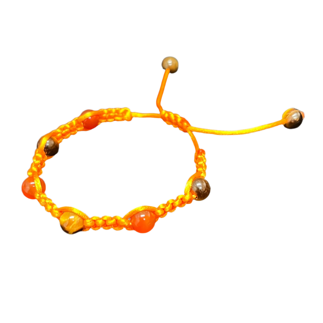 The Gem and Stone Beach Bracelets by Claire are exquisitely handcrafted with orange thread and beads, showcasing a knotted design with adjustable ends, making them the perfect accessory displayed on a black fabric background.