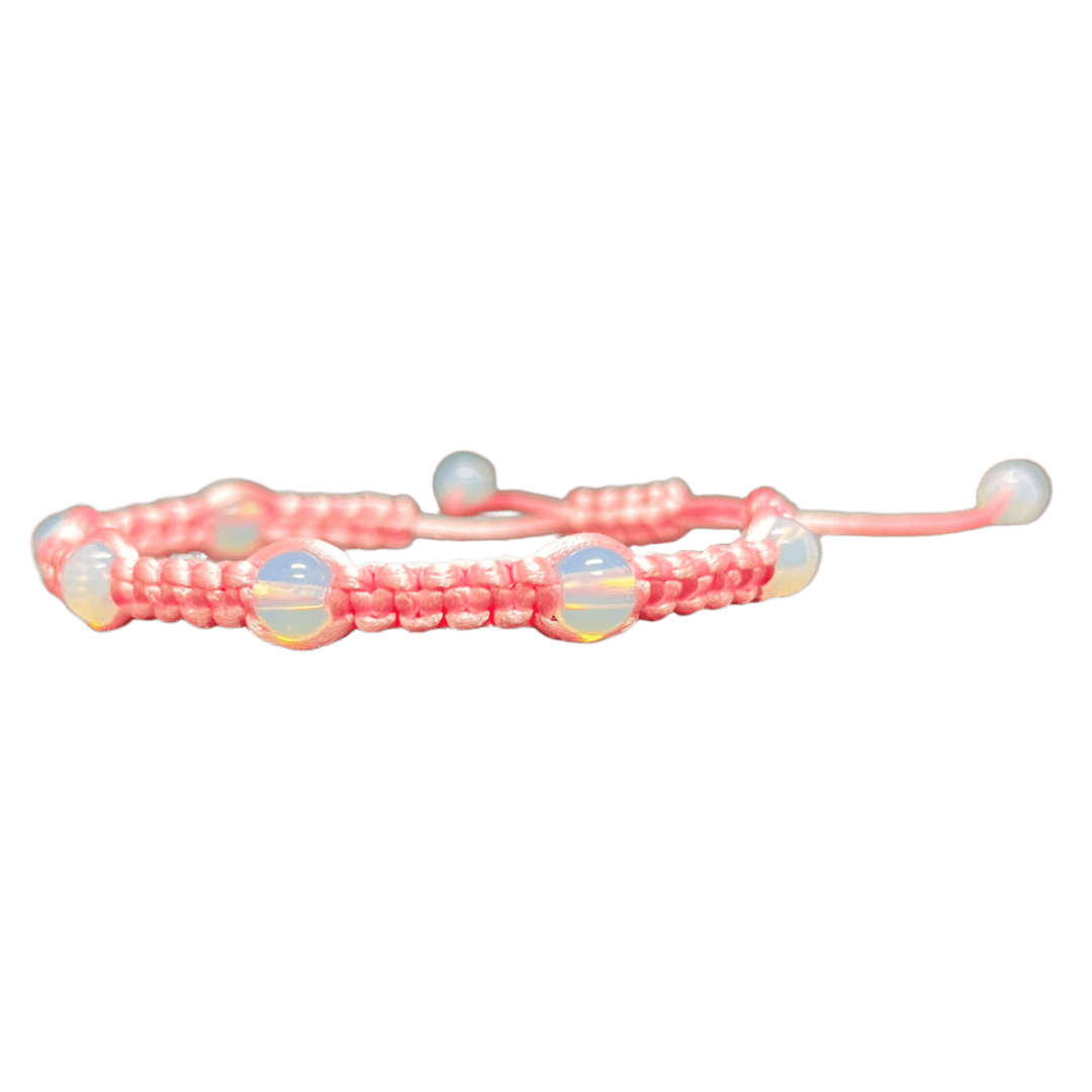 The Gem and Stone Beach Bracelet by Claire, intricately handcrafted with pink thread and adorned with seven iridescent beads, is elegantly showcased against a black background to highlight its unique charm.