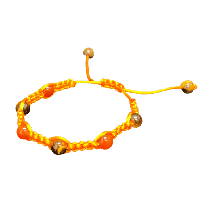 Introducing the Gem and Stone Beach Bracelets by Claire, a distinct beachwear accessory featuring a yellow braided cord adorned with round beads in amber and brown hues, elegantly displayed on a dark fabric backdrop.