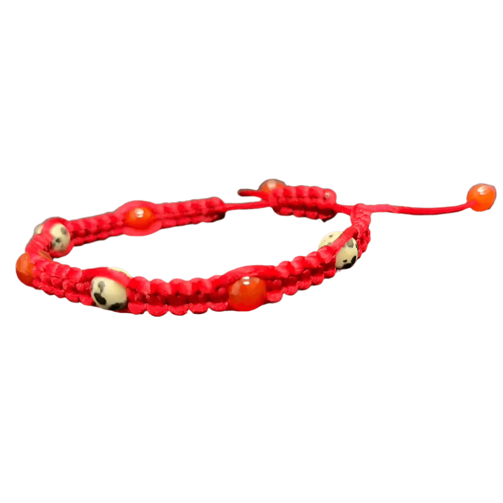 The Gem and Stone Beach Bracelet by Claire is a unique accessory, featuring a distinctive red cord enhanced with white beads decorated with black skull designs and vivid orange accents. This handcrafted bracelet includes an adjustable pull string, capturing the essence of distinctive gemstone jewelry and making it an ideal addition to any outfit.