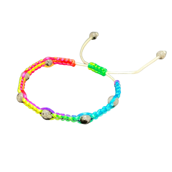 The Gem and Stone Beach Bracelets by Claire feature vibrant sections of neon pink, orange, yellow, green, and blue intricately woven with small metallic beads. This handcrafted bracelet is set against a black background that enhances its lively colors and includes an adjustable white cord for the perfect fit.