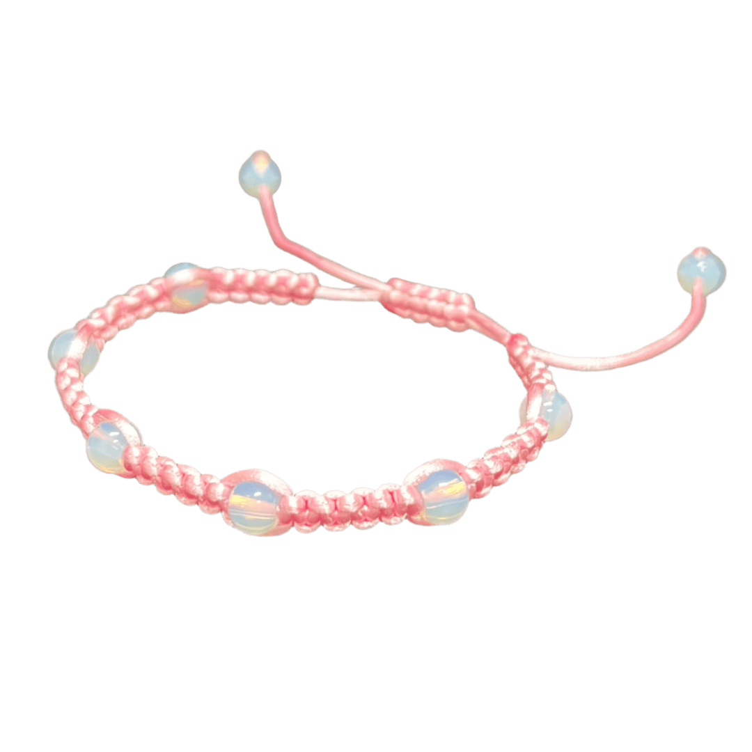 The Gem and Stone Beach Bracelet by Claire is showcased on a black background, featuring a pink woven design adorned with round iridescent beads. This handcrafted bracelet offers an adjustable closure with dangling bead ends, making it a distinctive piece of beachwear.