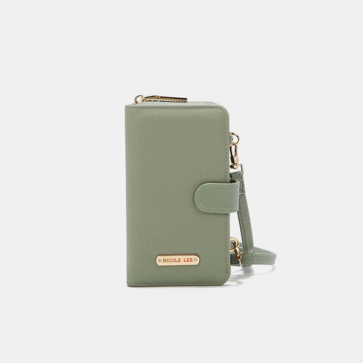 The Nicole Lee USA 2 Piece Phone Case Crossbody Wallet, in sage green vegan leather, has a zip-around top and gold button clasp. It includes a detachable strap and small engraved gold plate on the front, set against a plain white background.