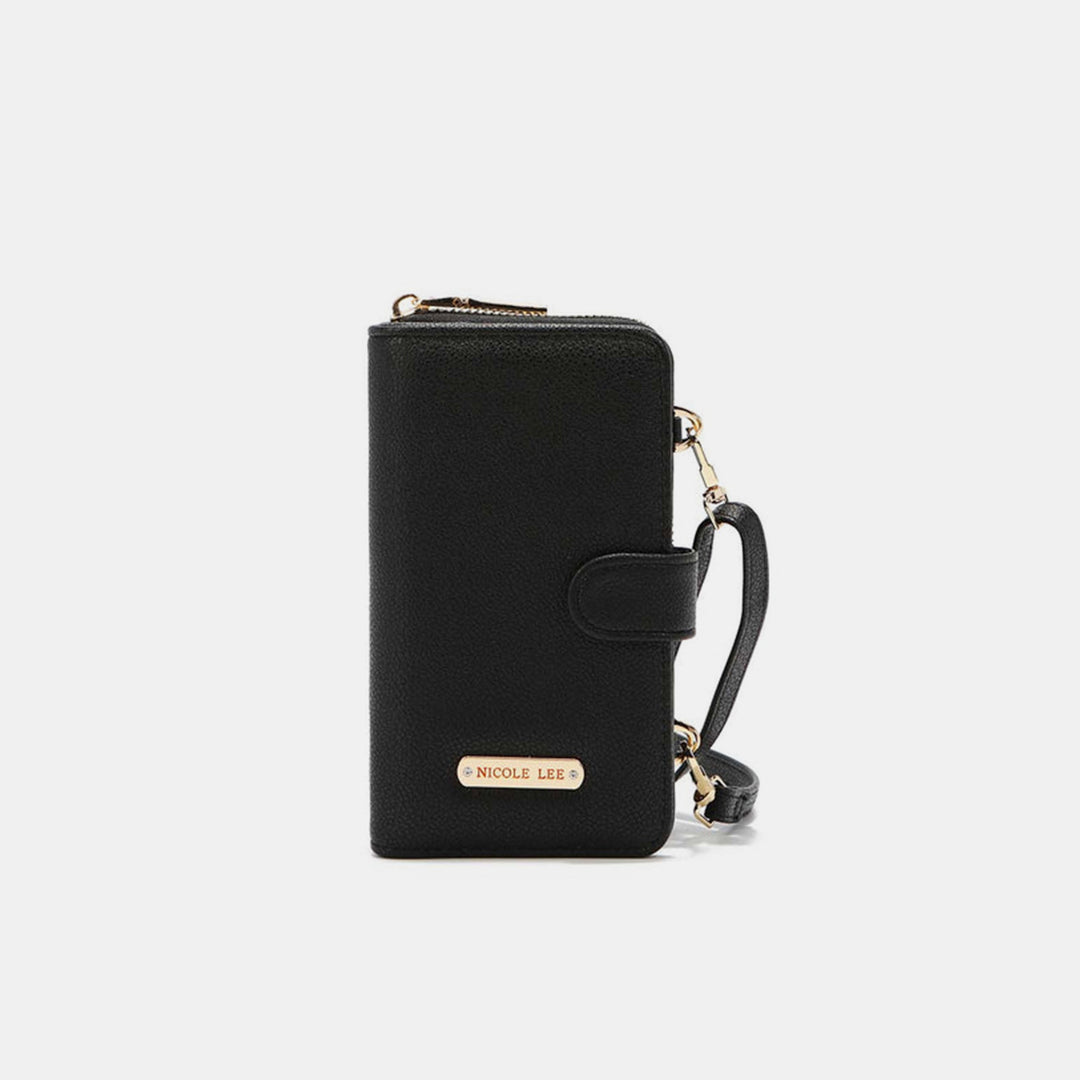 The Nicole Lee USA 2 Piece Phone Case Crossbody Wallet is a sleek black accessory with a wrist strap, gold zipper, and snap closure. Made from vegan leather, it features a metal nameplate with engraved text on the front, all set against an elegant light gray background.