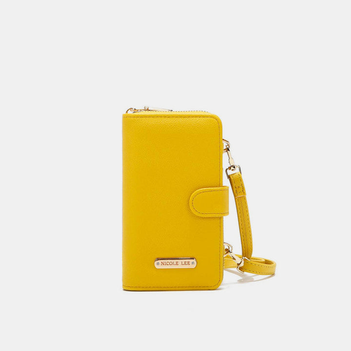 The Nicole Lee USA 2 Piece Phone Case Crossbody Wallet is a yellow vegan leather crossbody with a wrist strap and snap button closure, featuring a metal brand logo plaque. The background is plain white.