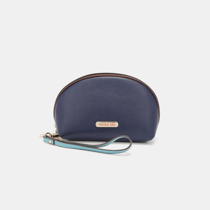 A navy semicircular wristlet from the Nicole Lee USA 3-Piece Color Block Handbag Set, crafted from vegan leather, features a brown zipper and turquoise strap. The front is adorned with a small gold plaque inscribed with NICOLI LEE.