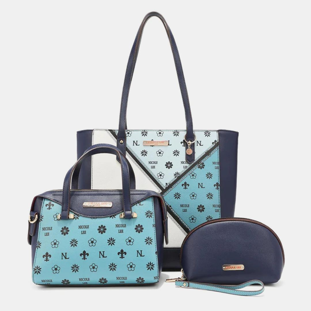 Explore the Nicole Lee USA 3-Piece Color Block Handbag Set, featuring a large tote, medium handbag, and small pouch in vegan leather. Adorned with a striking blue and white geometric floral pattern and Nicole Lee branding, the tote and handbag have dark handles; the pouch has a wrist strap.