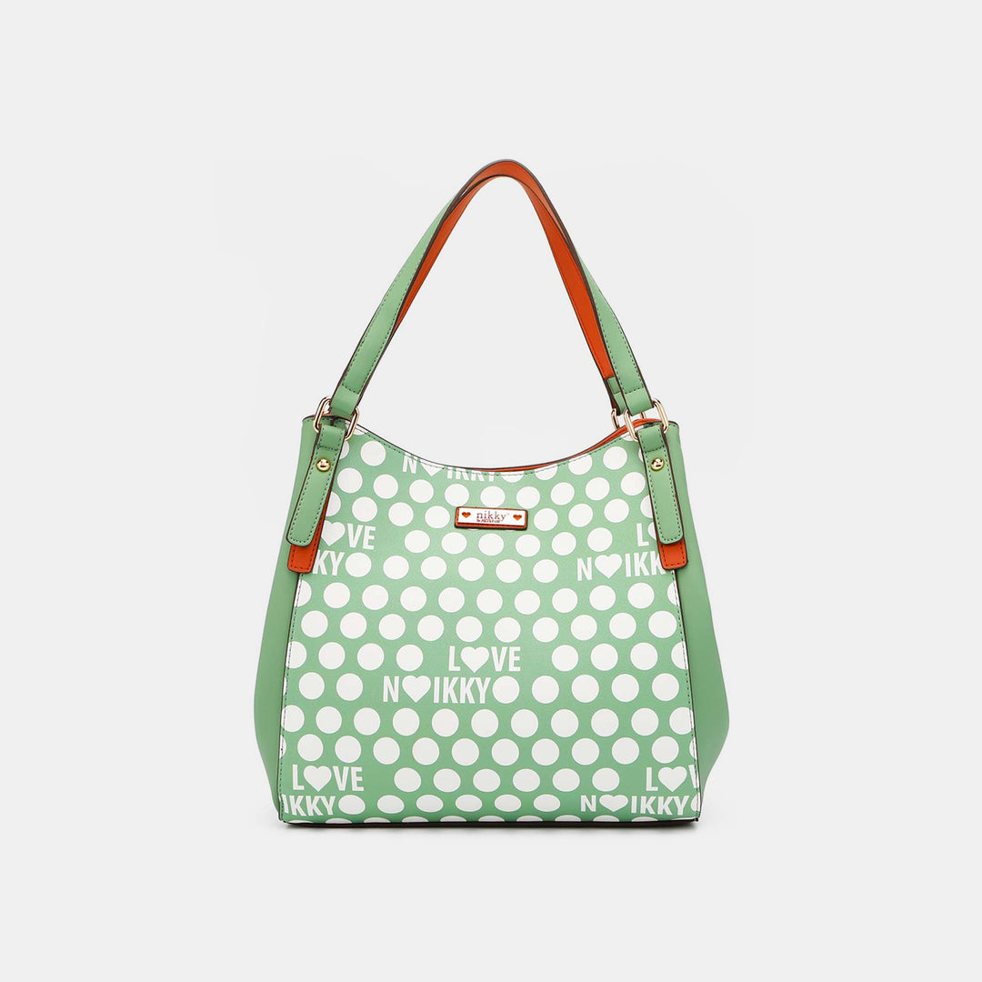 The Nicole Lee USA Contrast Polka Dot Handbag is a green vegan leather bag with white polka dots, I LOVE NIKKY text, orange accents on the handles and sides, gold hardware, a structured design, and a small logo plaque on the front.