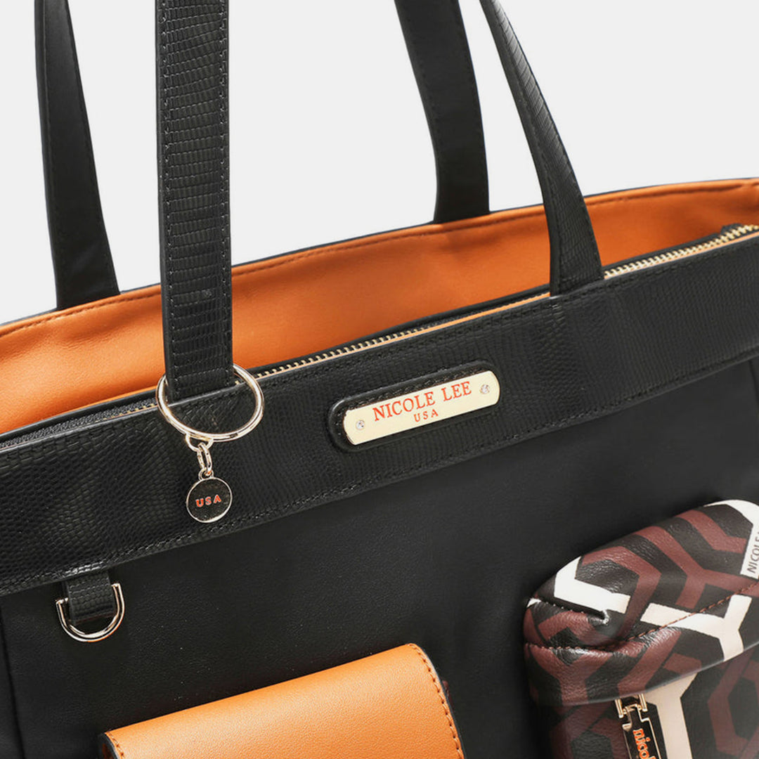 Close-up of the Nicole Lee USA Geometric Pattern Tote Bag, crafted from black vegan leather with an orange interior lining. The handbag is adorned with a gold nameplate and a detachable charm, accompanied by a small pouch featuring a geometric pattern that complements its neutral colorway.