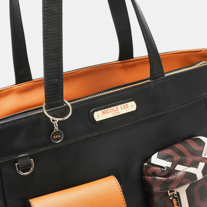 Close-up of the Nicole Lee USA Geometric Pattern Tote Bag, crafted from black vegan leather with an orange interior lining. The handbag is adorned with a gold nameplate and a detachable charm, accompanied by a small pouch featuring a geometric pattern that complements its neutral colorway.