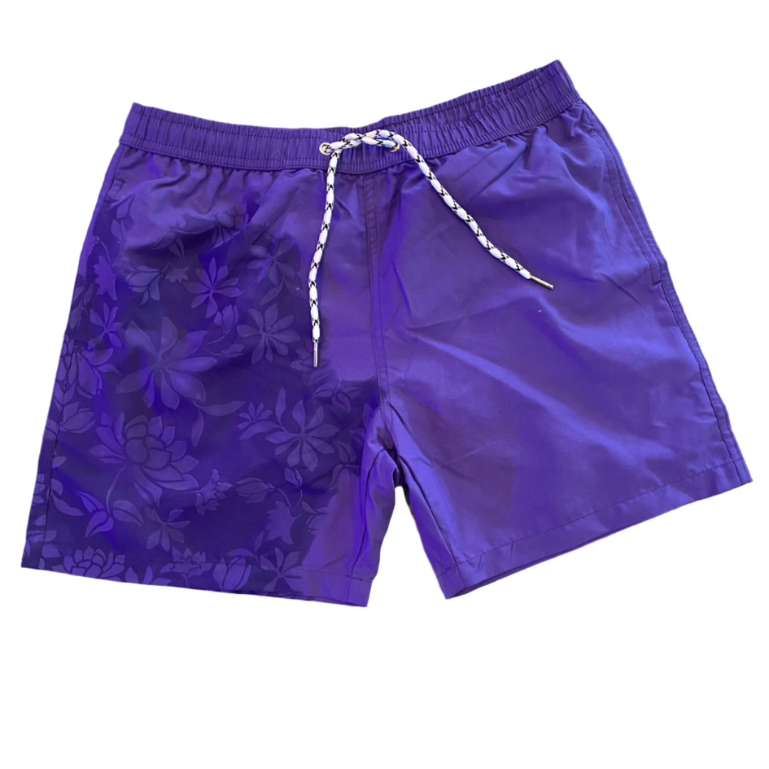 Hibiscus Flower Pattern Changing Trunks Mens in purple with a drawstring waist and hibiscus pattern on one side.