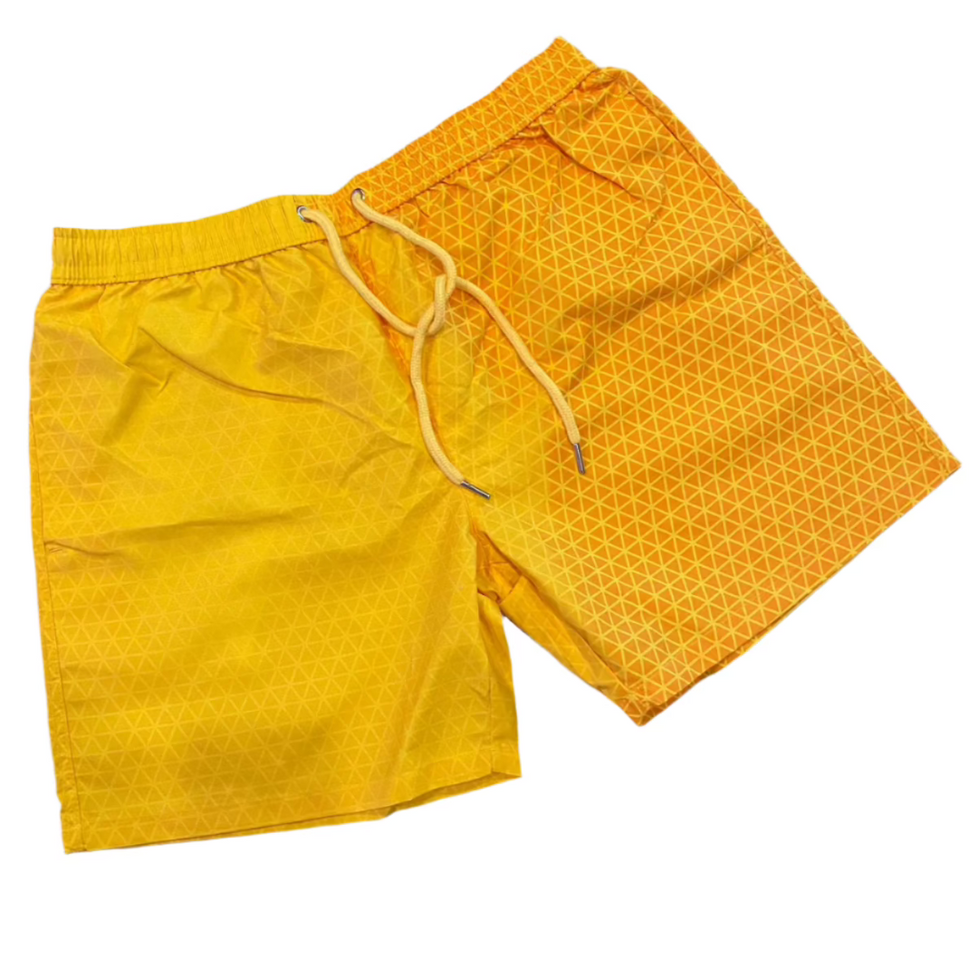 Color changing shorts kids swim trunks sunburst geo pattern. The patter disappears when heat is applied Changing from a orange to yellow - Kameleon Swim