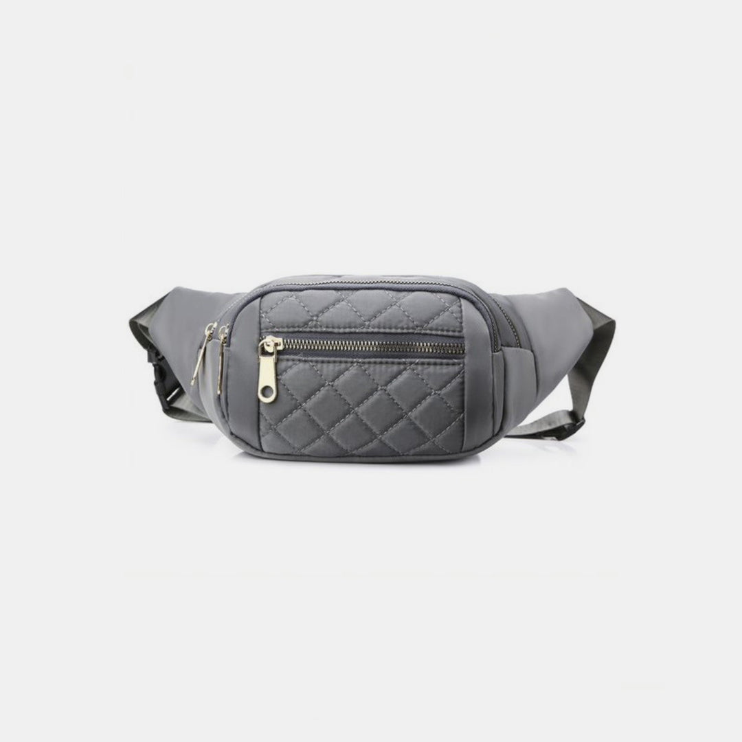 The Zenana Quilted Multi Pocket Waist Belt Bag, featuring a gray color with a front zippered pocket and adjustable strap for hands-free use, complete with gold-toned zipper hardware, is showcased against a plain white background.