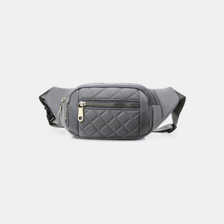 The Zenana Quilted Multi Pocket Waist Belt Bag, featuring a gray color with a front zippered pocket and adjustable strap for hands-free use, complete with gold-toned zipper hardware, is showcased against a plain white background.