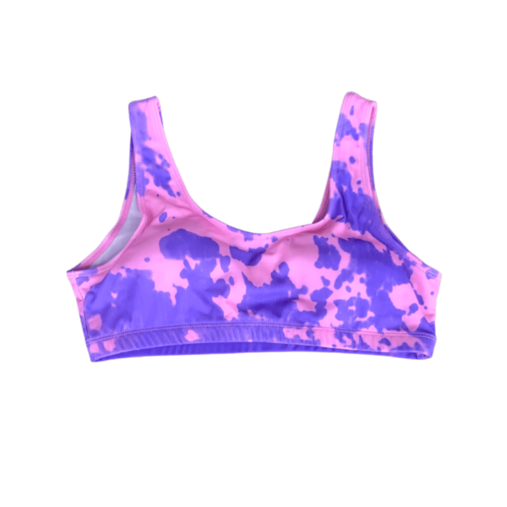 Color changing candy splash high waisted bikini top that is partially changed.  Full change of color comes with temperature changing the bikini from purple to pink when activated. Kameleon Swim