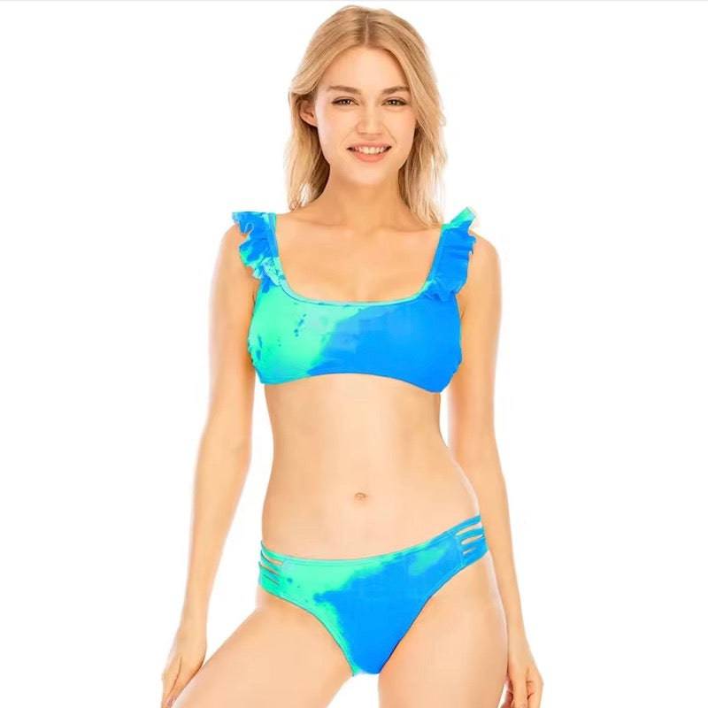 Sea foam color changing swimsuit with frills on the shoulder straps in a sea foam Kameleon color. Changing from blue to sea green. Kameleon Swim